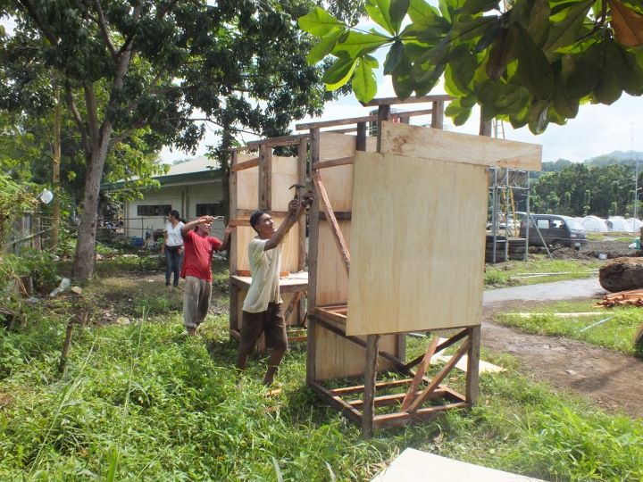 Constructing urine diversion dehydration toilets on the run-down to New Year at Tent City, Iligan, Philippines